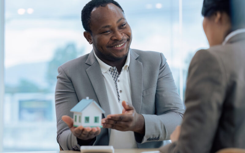 Real Estate Agent and client talking about Property insurance and security concept about house to client before sign contract.
